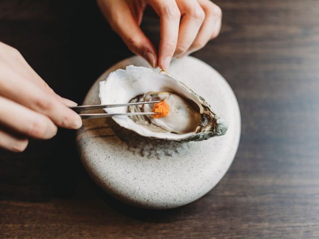 a fresh oyster on a stone plate at Mu, Canberra