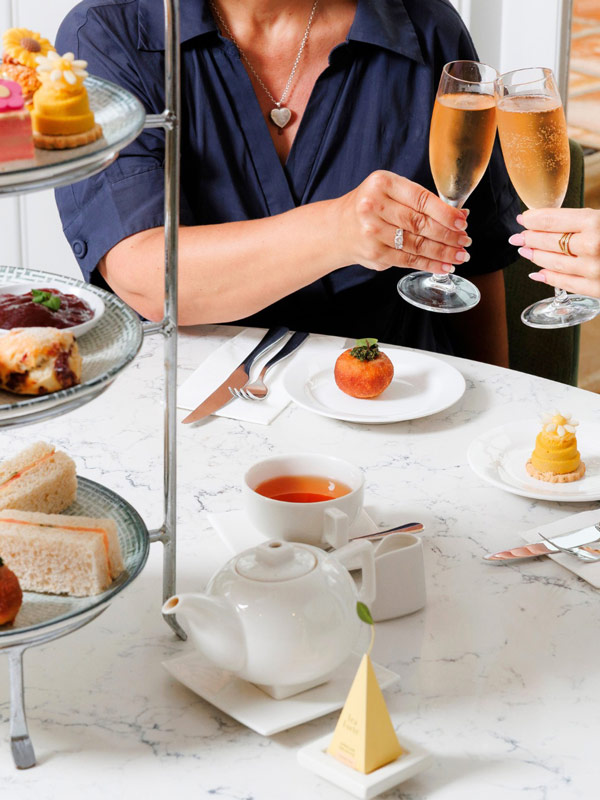 two women toasting with champagne at a table with food and drinks, InterContinental Sanctuary Cove Resort