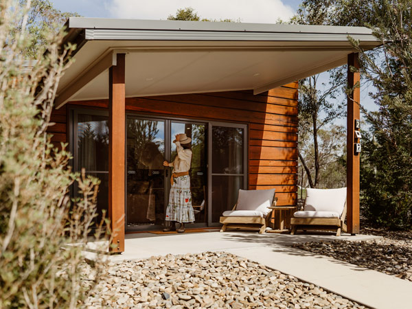 a woman standing outside Hamilton House