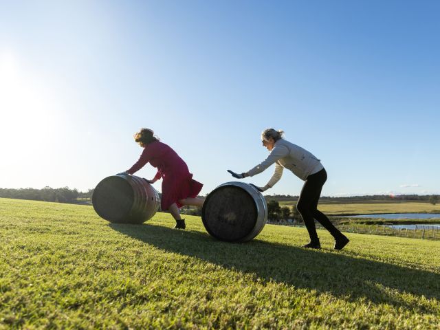 two people rolling barrels in Hunter Valley