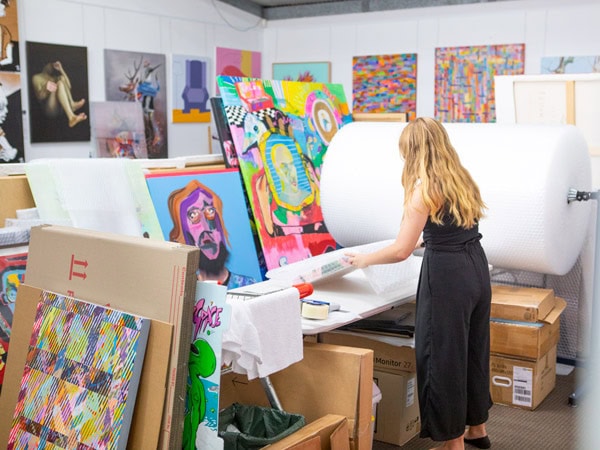 a woman arranging art and paintings at 19 Karen, Gold Coast