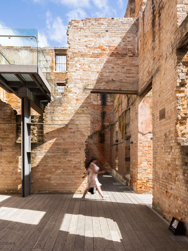 a woman walking inside The Port Arthur Historic Site