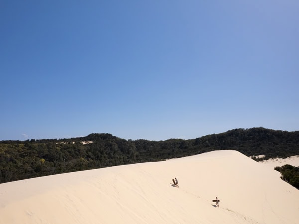 gliding down the dunes on Moreton Island with Australian Sunset Safaris