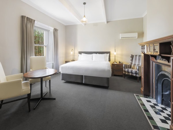 a bedroom with a window and a fireplace at Best Western Olde Maritime, Warrnambool