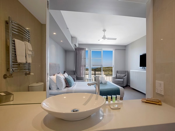 a room with a balcony at Deep Blue Hotel and Hot Springs, Warrnambool