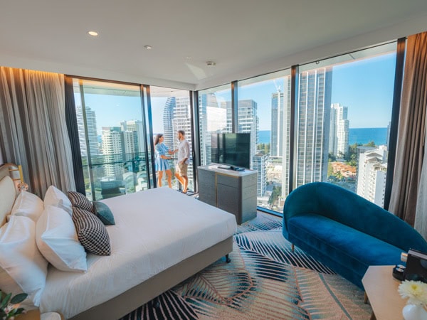 a couple relaxing in the balcony of their suite at Dorsett Gold Coast