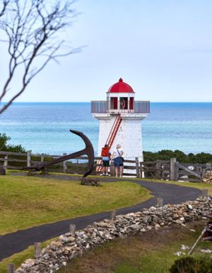 two people standing outside the lighthouse at Flagstaff Hill Maritime Village lighthouse