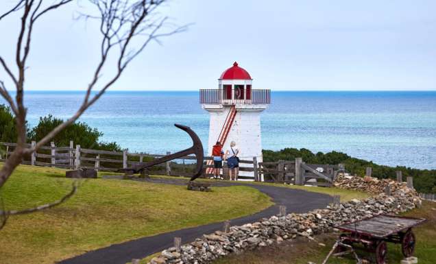 two people standing outside the lighthouse at Flagstaff Hill Maritime Village lighthouse