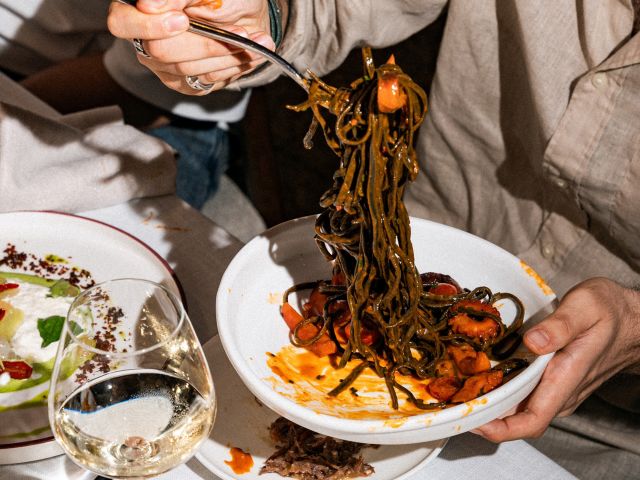 holding a fork full of pasta at Como Restaurant, Brisbane