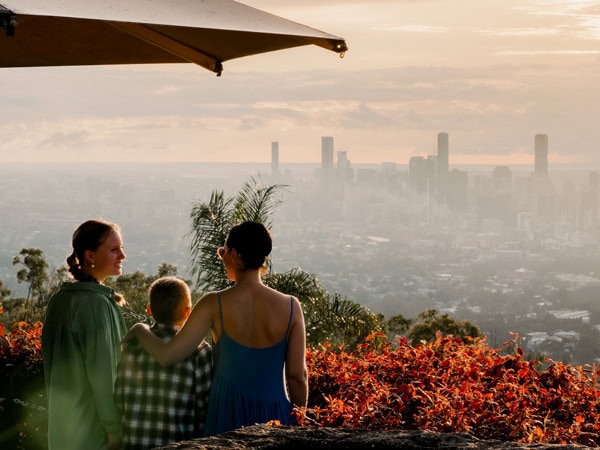 a family admiring views from Mount Coot-tha Lookout