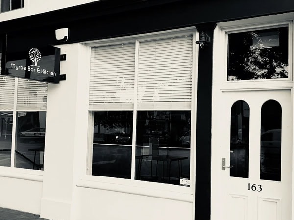 the black and white exterior of Myrtle Bar & Kitchen, Warrnambool