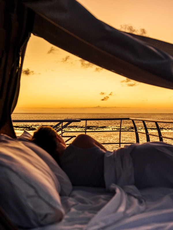 Woman in Reefsleep bed at sunrise