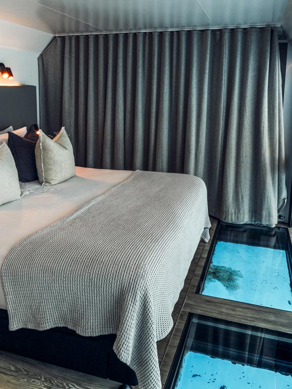 Bed and glass floor in reefsuites