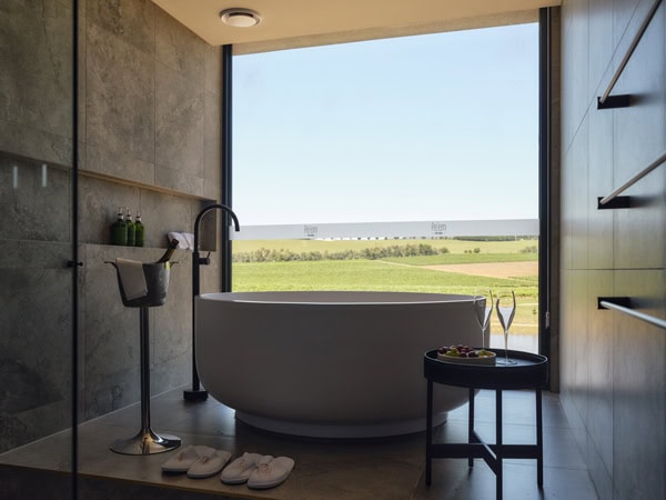 a bathtub with views of the surrounding vineyard at Re’em Yarra Valley