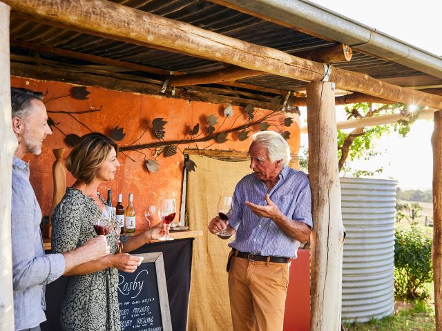 Couple enjoying a wine tasting experience with winemaker Gerry Norton-Knight at Rosby Wines & Guesthouse, Eurunderee.