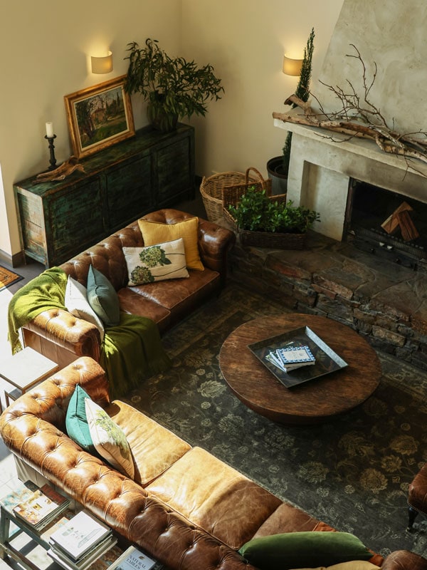 the living area with fireplace and leather couches at Farmhouse at Meletos