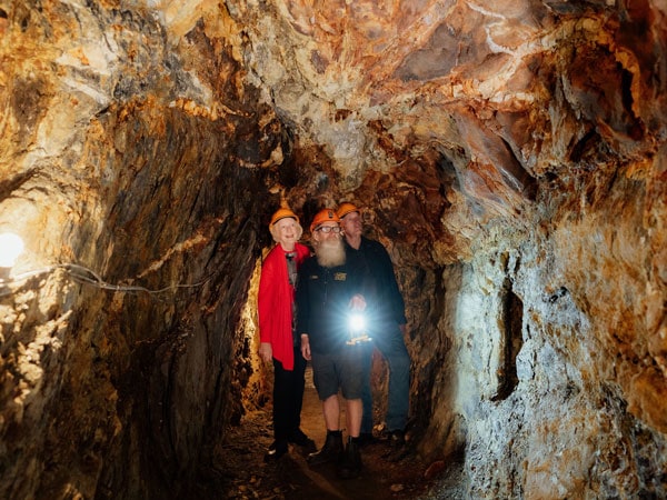 A guide leads a couple into the Walhalla Mine in Victoria