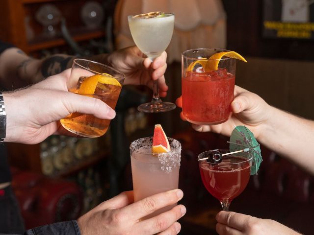 hands raising drinks at Foxtrot Unicorn, Perth