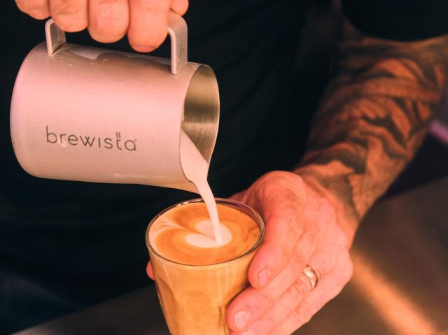 pouring milk into coffee at Standing Room Only Coffee Bar, Perth