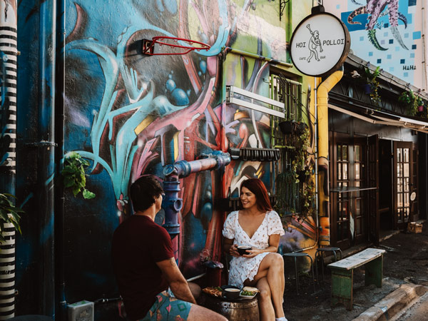 a couple dining outside Hoi Polloi Cafe, Townsville