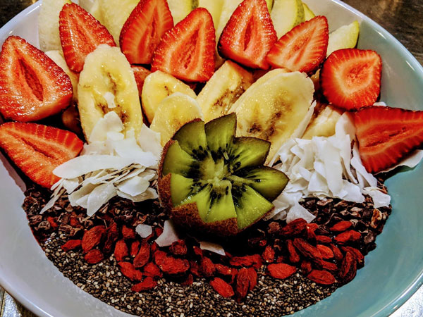 a healthy bowl topped with fresh fruits and chia seeds at Odyssey on the Strand, Townsville