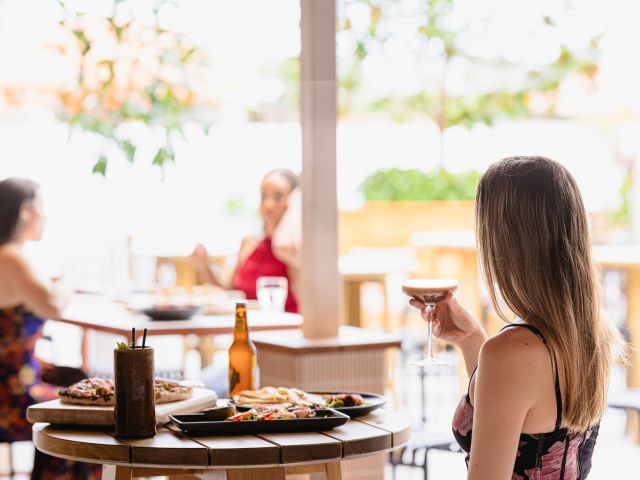 a woman enjoying drinks at The Beaumont, Brisbane