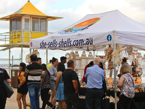 people buying seashell crafts at a beachside stall, Surfers Paradise Beachfront Markets