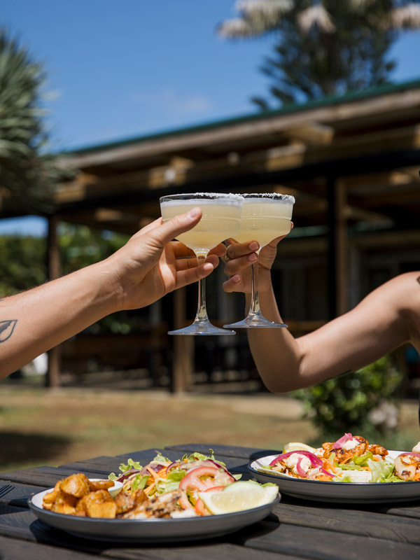 clinking cocktail glasses at Salty Beer Garden, Norfolk Island