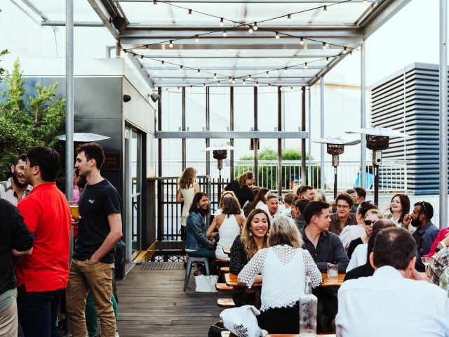 people enjoying drink at the lower deck of Mechanics Institute rooftop bar in Perth