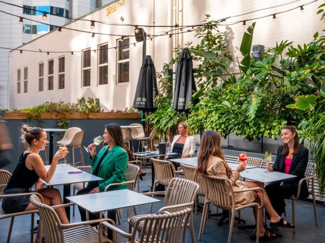 people enjoying drinks at the lush rooftop terrace of Terrarium, Perth