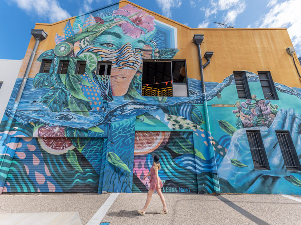 a woman admiring street art in Townsville