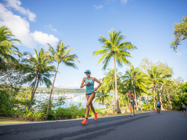 a female triathlete running at the Hamilton Island Triathlon
