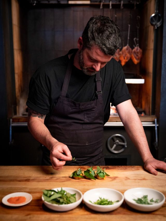 a chef busy preparing dishes at Agnes, Fortitude Valley