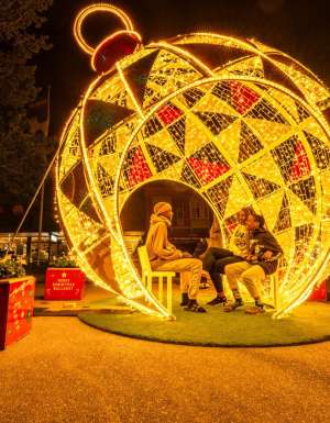 people sitting inside a huge Christmas ball in Ballarat