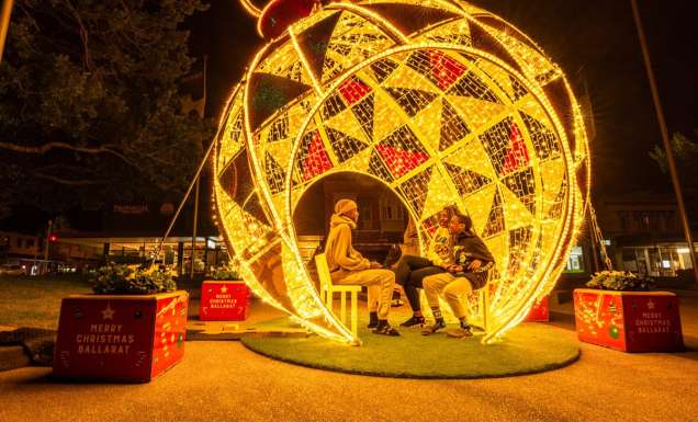 people sitting inside a huge Christmas ball in Ballarat