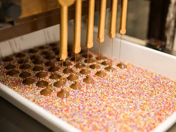 Chocolate freckles being made at Haigh's Chocolates in Adelaide