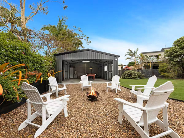 outdoor chairs set around the bonfire at Pantai Indah Cottage, Hervey Bay