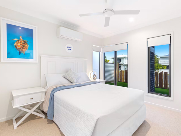 a whitewashed bedroom at Luxe by the Marina, Hervey Bay