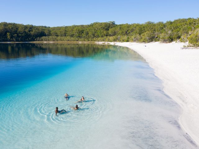 group of friends swimming in lake mckenzie on k'gari fraser island