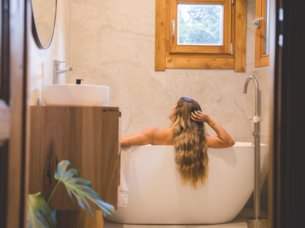 a woman relaxing in a tub at The Cabin, Lord Howe Island accommodation