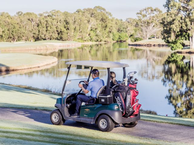 golfers riding a golf buggy at Noosa Springs Golf and Spa Resort
