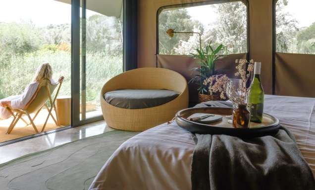 woman sitting on deck of Peninsula Hot Springs Glamping
