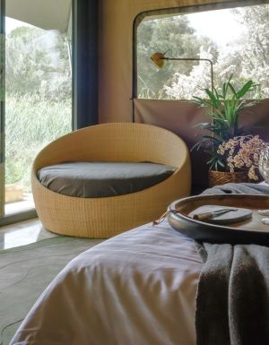 woman sitting on deck of Peninsula Hot Springs Glamping