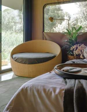 woman sitting on deck of Peninsula Hot Springs Glamping