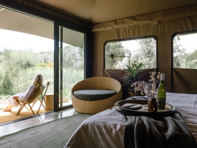 woman sitting on deck of Peninsula Hot Springs Glamping
