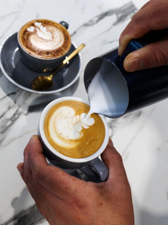 pouring milk over coffee at Rush Roasting Co., Bowral cafes