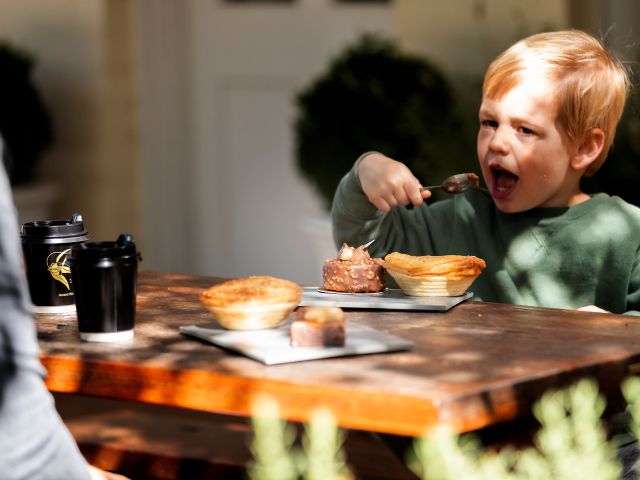 a little boy enjoying desserts at Gumnut Patisserie, Bowral cafes