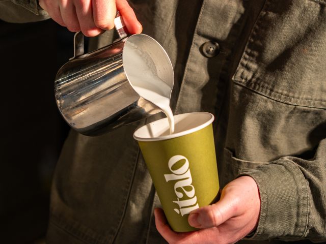 pouring milk into a coffee cup at Italo, Bowral cafes