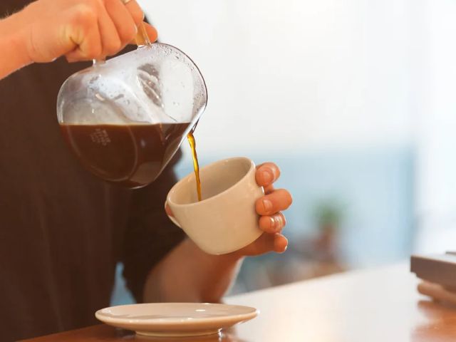 pouring coffee into a cup at Moonstruck, Noosa