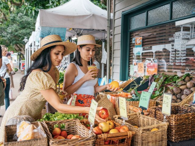 two women buying fresh fruits at Eumundi Markets